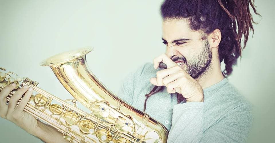 Adi playing saxophone during a live Los Angeles celebration