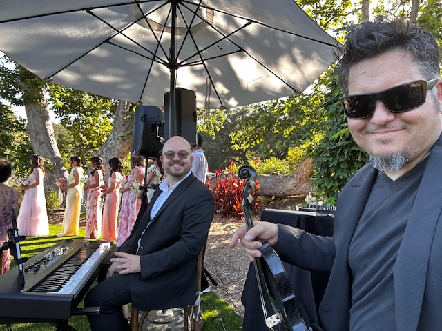 Piano and violin duo performing live at an outdoor wedding in Orange County