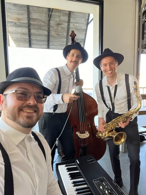 Piano saxophone and bass musicians performing live