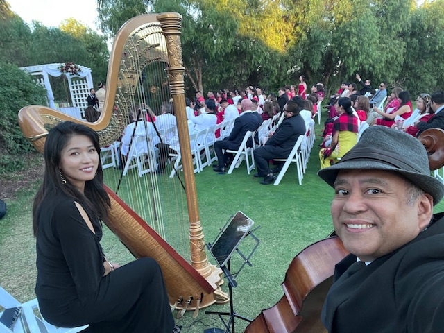 Harp And Cello Duo Performing For Guests At An Outdoor Event
