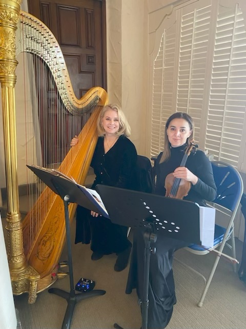Harp And Violin Duo Performing Indoors At A Los Angeles Event