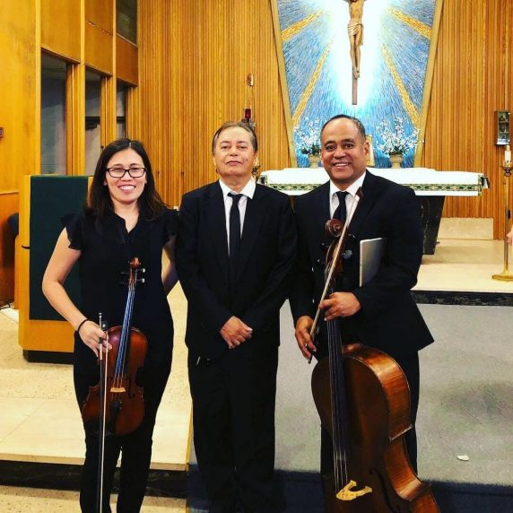Cecile performing violin with a classical string ensemble