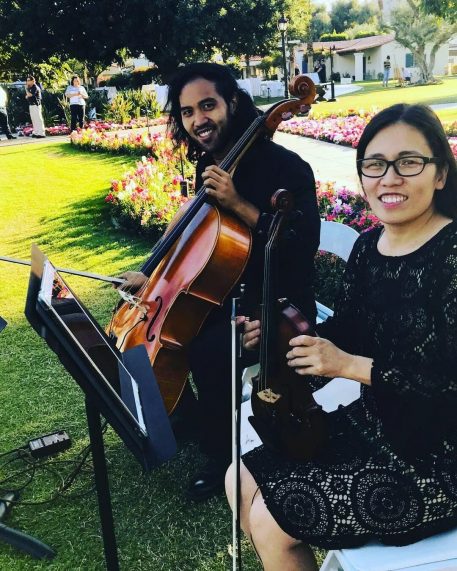 Cecile performing as a wedding violinist during an outdoor ceremony