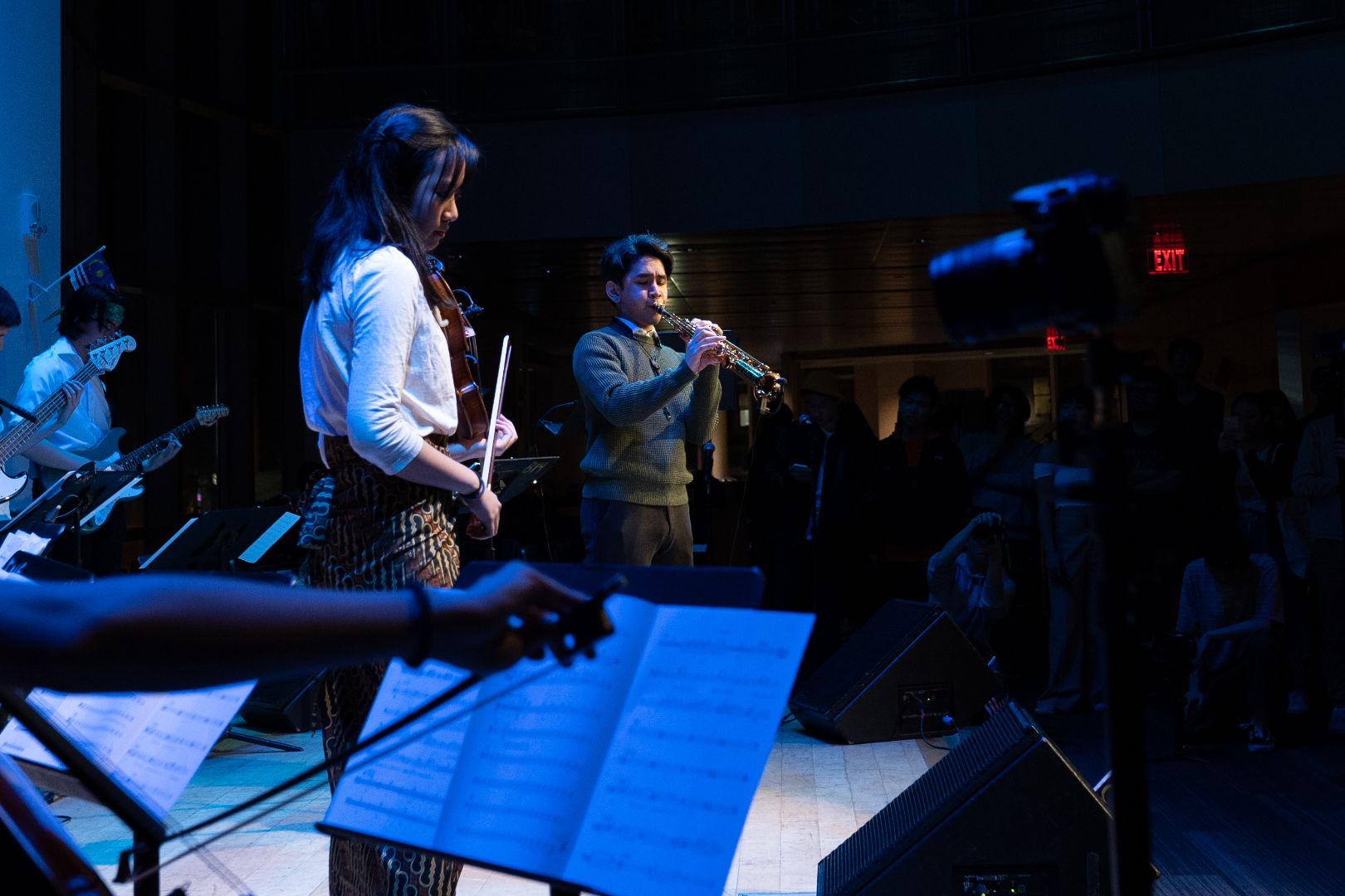 De Leon Brothers musicians performing with a live ensemble on stage