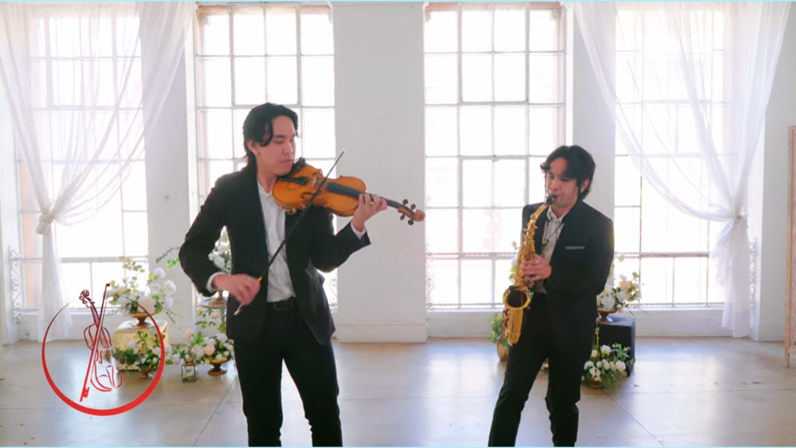 Gabe performing violin with saxophone for a wedding event