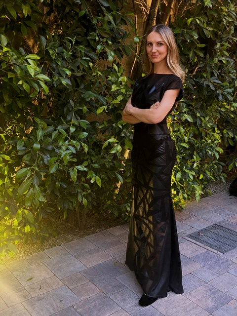 Editorial portrait of Mila standing outdoors before a live performance