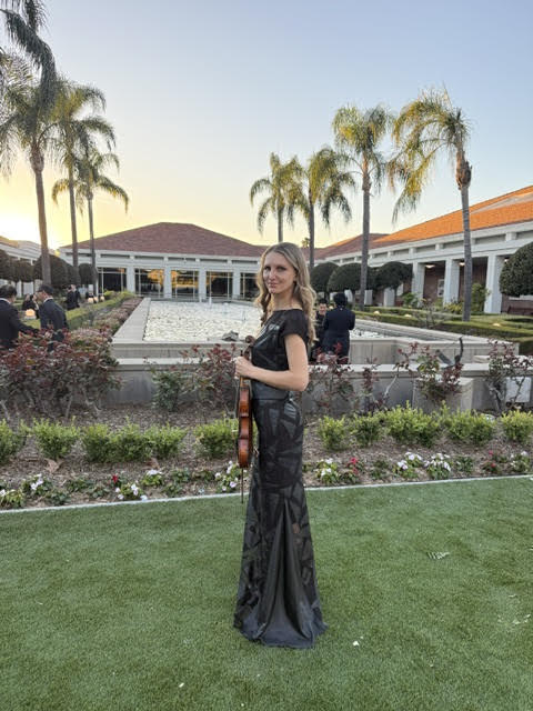 Mila performing violin music at a luxury Southern California venue