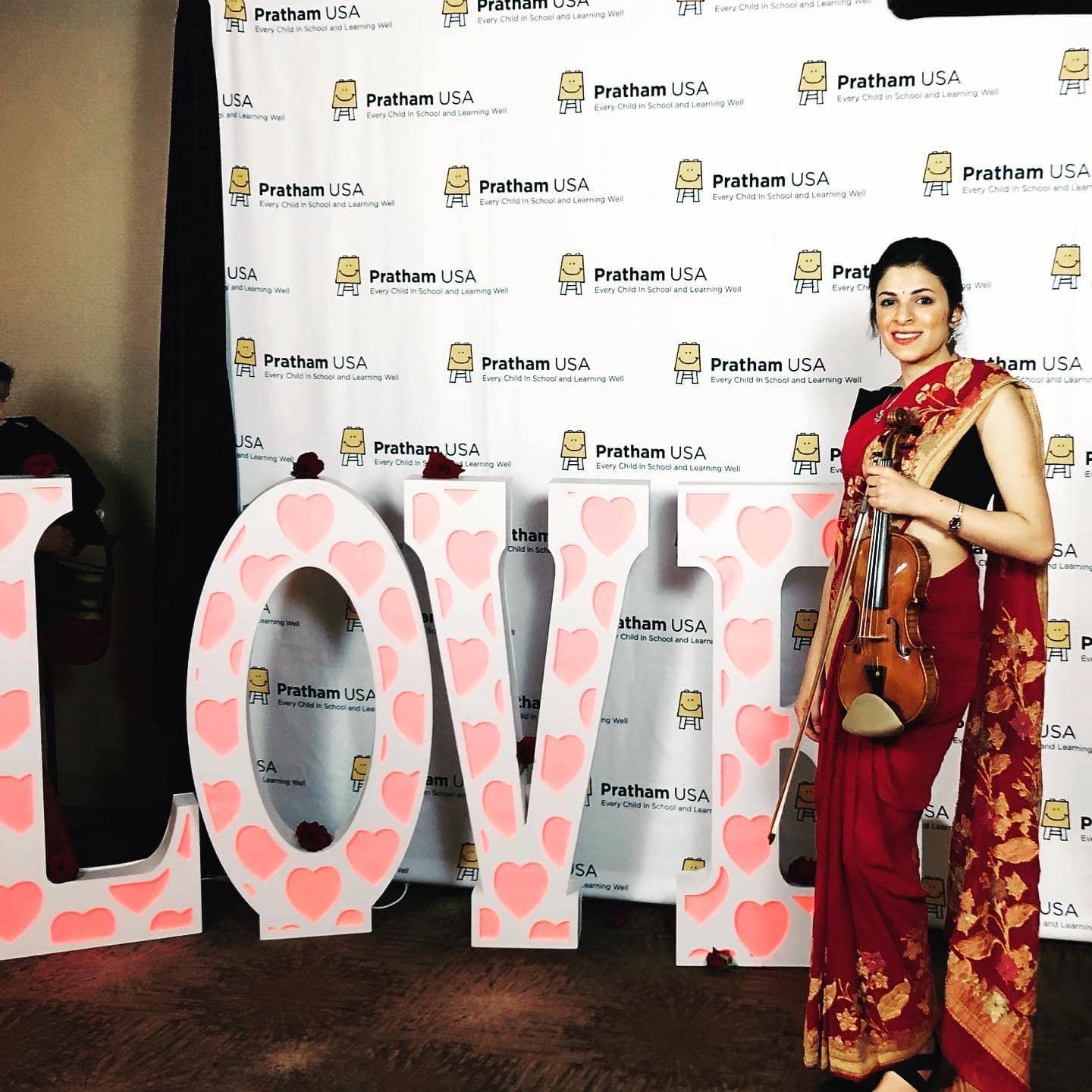 Priyanka standing with violin outside Griffith Observatory in Los Angeles