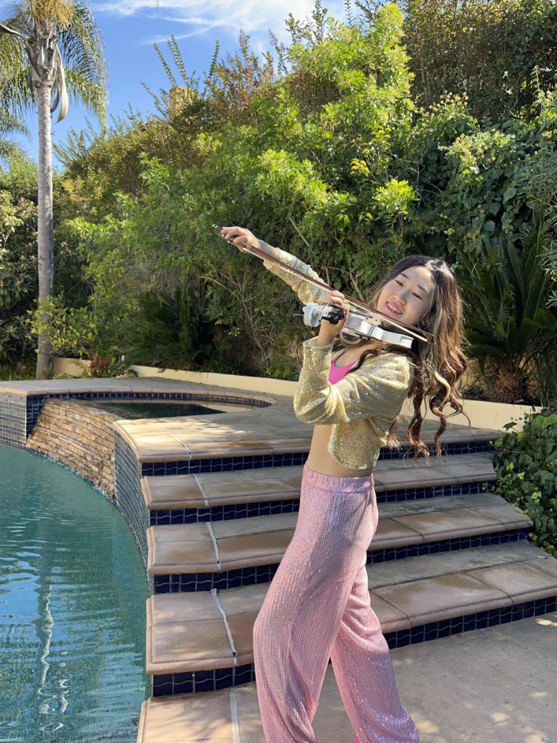 Tingting Performing Electric Violin Beside A Luxury Pool