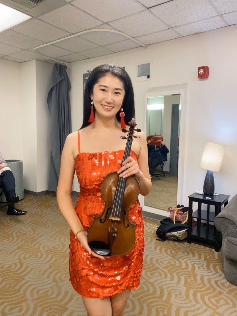 Tingting Holding Her Violin Before A Live Performance
